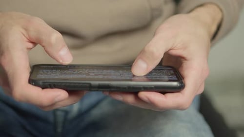 Using a Smartphone Closeup a Man's Hands Use the Device to Access Mobile Internet and Use Various