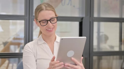 Woman Using Tablet in an Office Setting
