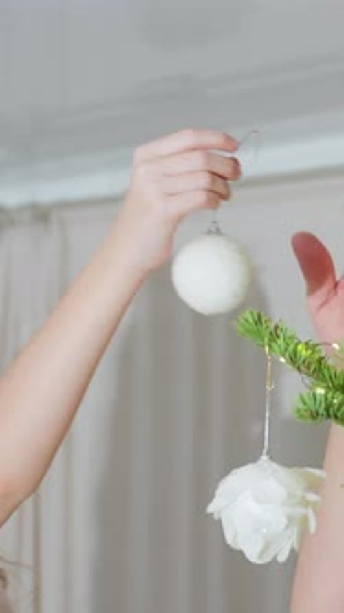 Girls Decorating Christmas Tree with White Ornaments
