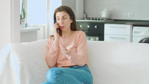 Young Woman Talking on a Mobile Phone Indoors