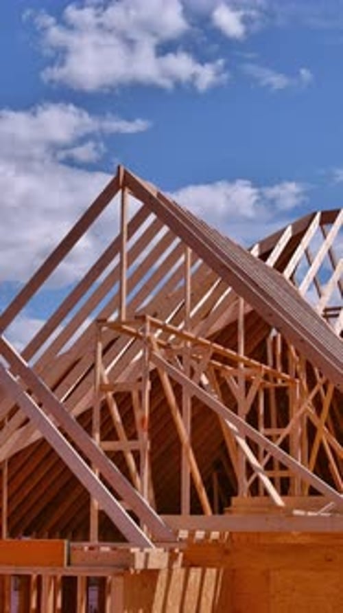 New House Roof is Constructed Using Trusses Supported By Beams That are Made From Wooden Frames