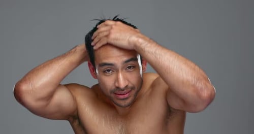 Face, cleaning and man with hygiene, skincare and cosmetics on a grey studio background
