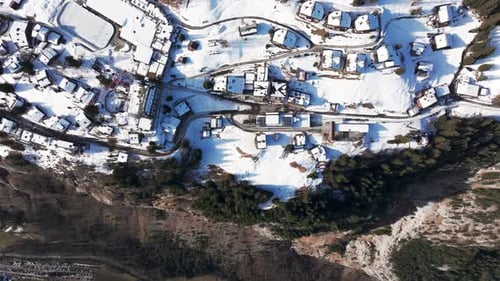 Aerial view of snowy Bernese Highland Switzerland village near mountain edge