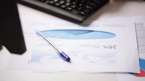 Businessman hands check charts and type on keyboard in modern office