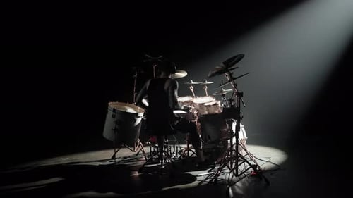Inspired Musician Playing Drum Set in Dark Studio Silhouette Shot in Backlit Professional Drummer