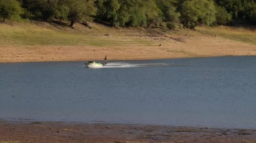 Water skiing in a blue lake. Extreme water sport.