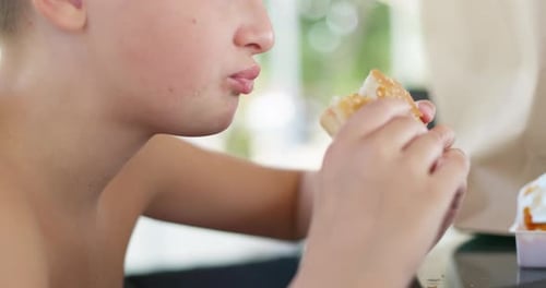 Blond Boy Eating Hamburger Close Up