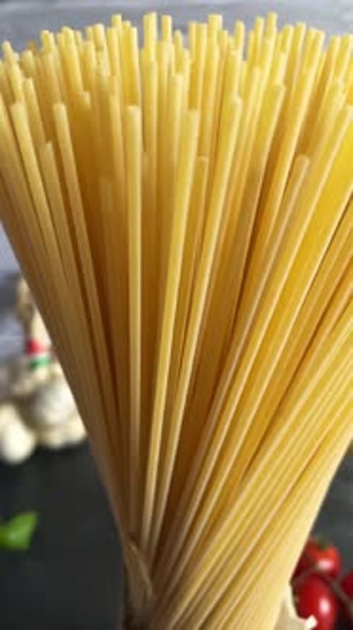 Closeup italian spaghetti pasta cooking ingredients spinning