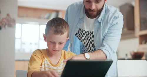 Boy Using Tablet with Adult Supervision at Home