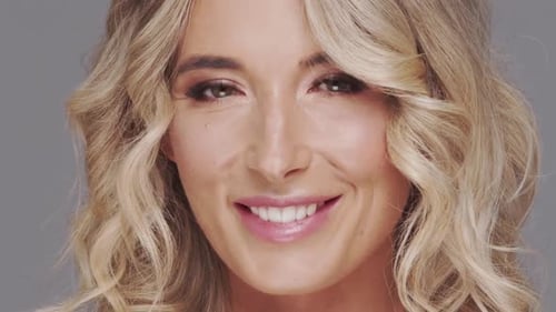 Studio Portrait of Young and Beautiful Blond Woman Over Grey Background Skin Care and Wellness