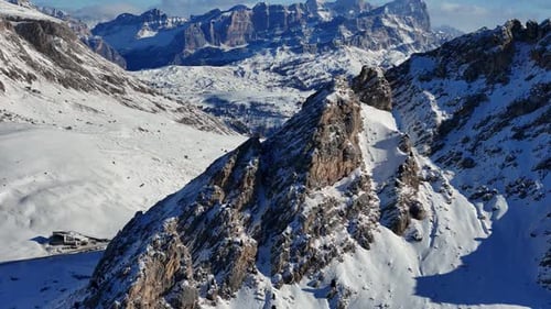 Reveal shot of Dolomites rock formation in the background during winter season (drone footage)