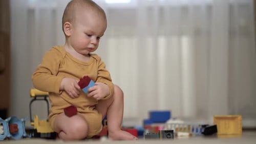 Baby Plays Alone With Colorful Building Blocks