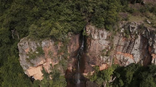 Aerial Waterfall Tracking Back to Reveal Forest and Pool of Water 4K