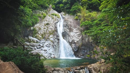 Stunning waterfall cascading through lush green nature, perfect destination for nature lovers and hi
