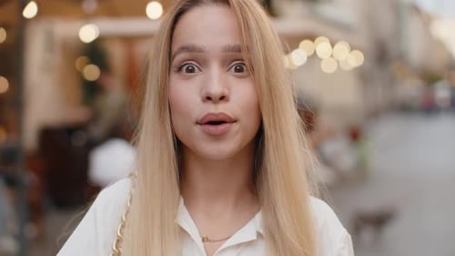 Young Woman Looking Surprised at Camera Shocked By Sudden Win Good Victory News Wow in City Street