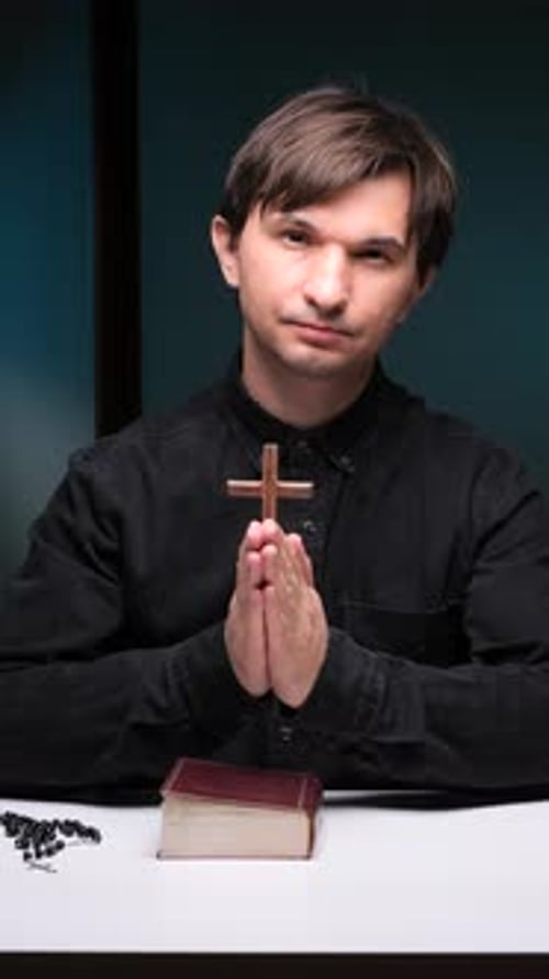Young Adult Praying With Bible And Rosary