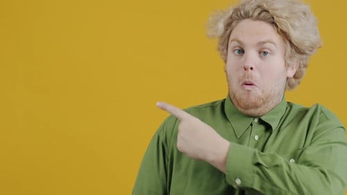 Blond Haired Person Points and Gives Thumbs Up