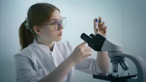 Young Adult Woman Studying Vile in Laboratory