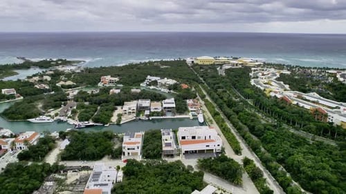 Luxurious beach house with an ocean view and yachts docked nearby