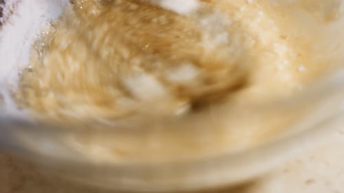 Whisk Mixing Batter and Flour in Glass Bowl