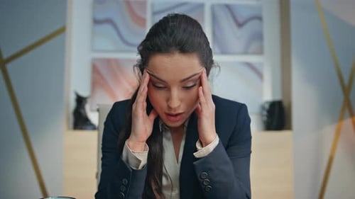 Business Woman Speaking at a Desk