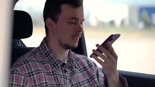 Adult Man Recording Voice Message in Vehicle