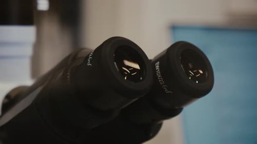 Close up view of a stereo ocular of a professional microscope. Laboratory setting.