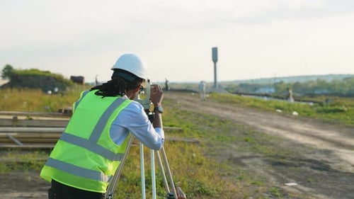 Construction Surveyor Using Theodolite on Site during Daytime