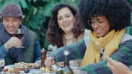 Friends Gather Around Table for Garden Lunch