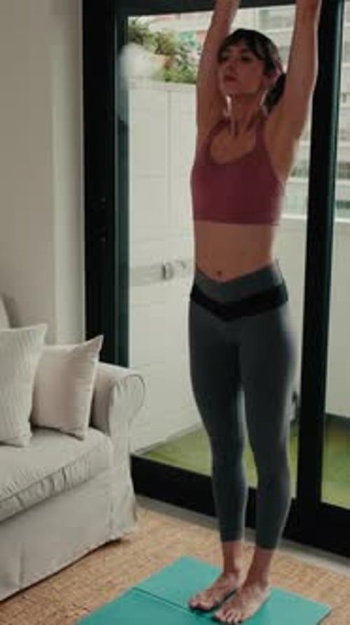 Woman Exercising and Practicing Yoga in Bright Home