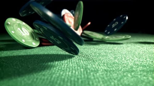 Casino Chips Falling on Green Table
