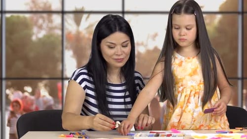 Mother and Child Crafting Art Together at Home
