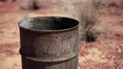 Old Empty Rusted Barrel on Sand