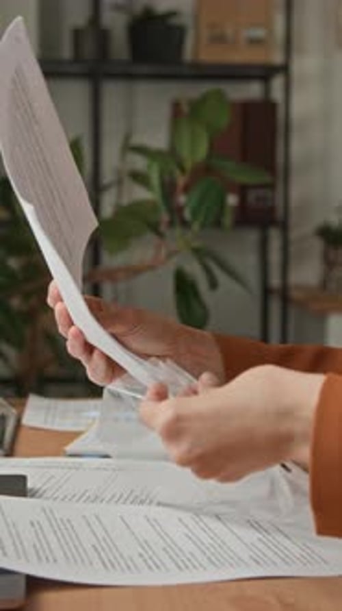 Office Professional Filing Documents at Desk