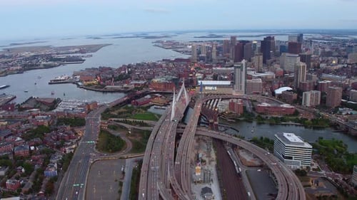 Aerial view of highway and city skyline at dusk