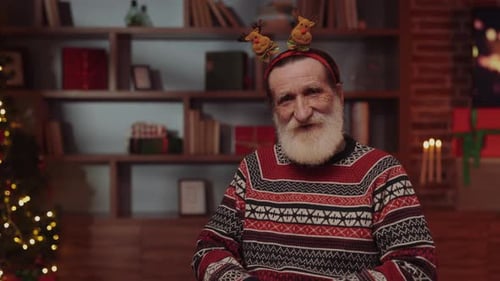 Portrait of Elderly Man in Wheelchair Sitting in New Year's Decorated Room at Nursing Home Senior
