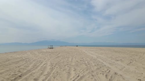 4k moving forward close to the ground clip over a peninsula on the tropical beach of Epanomi, Halkid