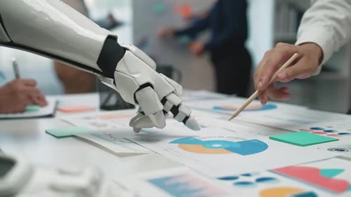 Robot Hand and People Reviewing Charts in Office