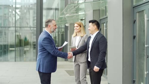 Business People Meeting Outside Office Building