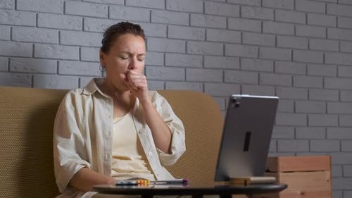 Woman Coughing During Telehealth Call at Home