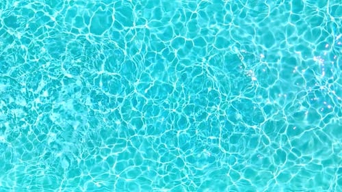 Blue Water in the Swimming Pool with Light Reflections