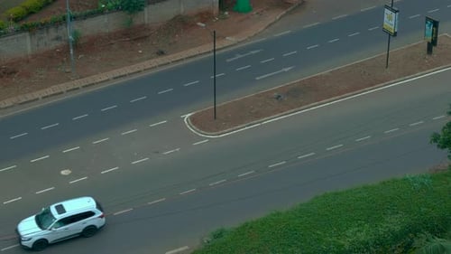View From The Top To The Road Along Which Cars Pass.