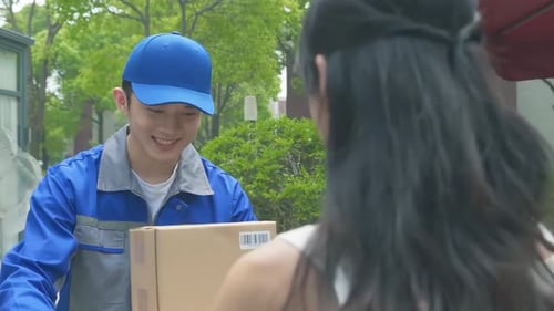Delivery Man Handing Packages to a Woman Outdoors