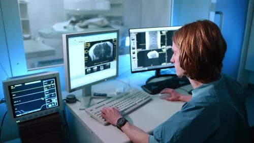 A Behind View of Veterinarian Looking at the Magnetic Resonance Image