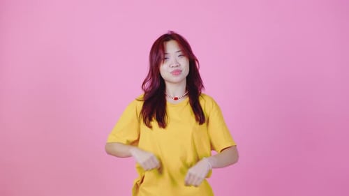 Young Woman Poses Confidently in Studio on Pink