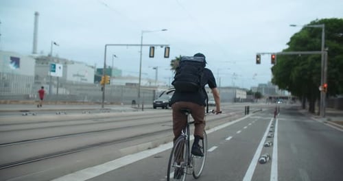 Camera Follow Commuter Cyclist on Bikelane in City