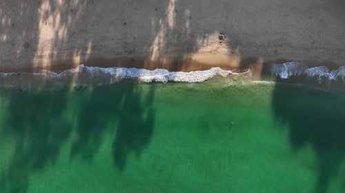 Aerial view of waves on sandy beach, Thailand.