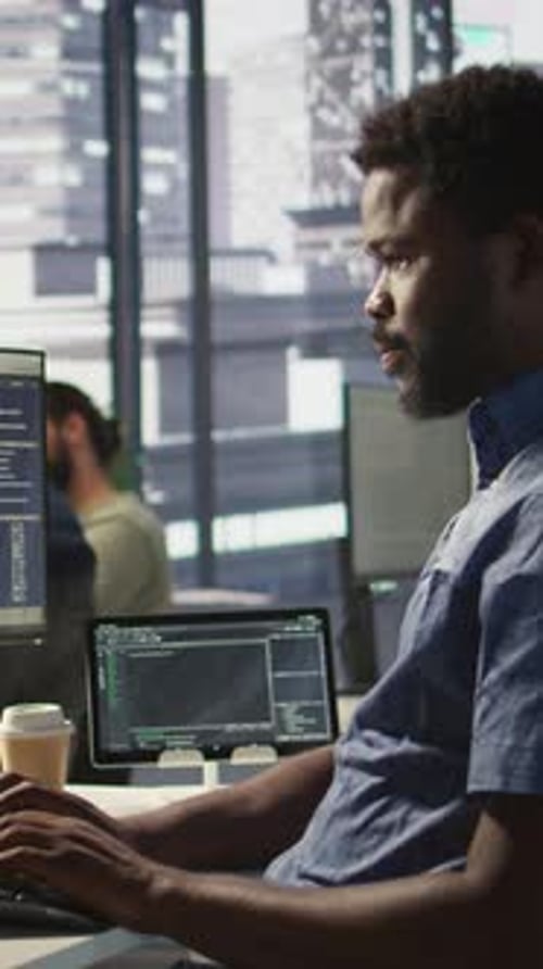 Vertical Video Close Up of IT Expert Programming in Office Using PC