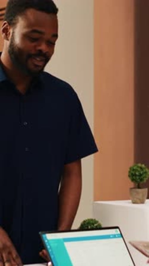 Vertical Video Receptionist Looking at Passports