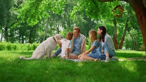 Family Relaxing with Dog in the Park
